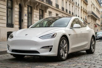 Berline électrique de marque asiatique garée dans une rue pavée européenne, vue en angle 3/4 avant mettant en valeur son design aérodynamique